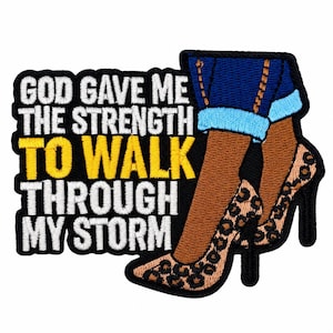 May include: An embroidered patch featuring the text GOD GAVE ME THE STRENGTH TO WALK THROUGH MY STORM in white and yellow thread. The design includes a pair of legs wearing blue cuffed jeans and high-heeled shoes with a leopard print pattern.
