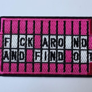 May include: A rectangular embroidered patch with a black border featuring a hot pink background with vertical black bars resembling a prison cell. The white text reads FUCK AROUND AND FIND OUT in black capital letters across the center.