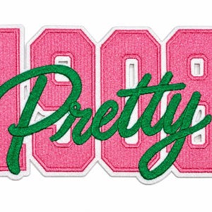 May include: An embroidered patch featuring the pink numbers 1908 with a white border. Overlaid across the numbers is the word Pretty in green cursive script. The design uses a varsity-style font for the numbers and a flowing script for the text.