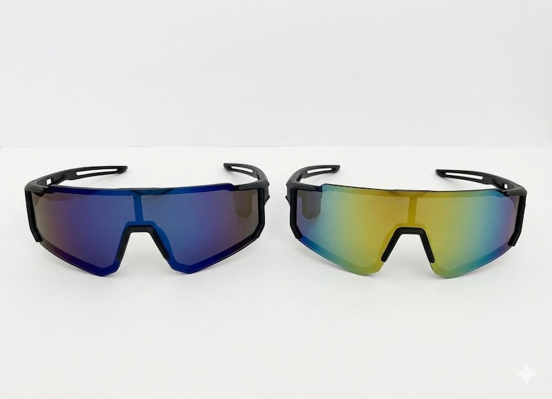 May include: Two pairs of sport sunglasses with a sleek, modern design. One pair features blue lenses, the other has yellow-green lenses. Both have black frames and a wraparound style, suitable for outdoor activities.