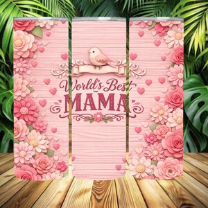 May include: A pink tumbler with a floral design and the text "World's Best MAMA." The design includes pink flowers, hearts, and a bird. The background has a wood grain pattern.