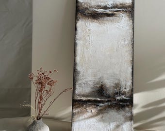 May include: Abstract textured wall art in a vertical rectangular format. The artwork features a palette of white, brown, and black, with a textured surface. A small white vase with dried flowers is in the foreground.