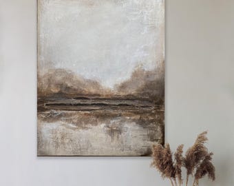 May include: Abstract landscape painting in neutral tones of beige, brown, and white. The artwork features a textured surface with a layered effect, evoking a sense of depth and serenity. The painting is displayed above a wooden table with decorative items.