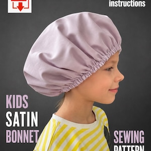 May include: A light purple satin bonnet with an elasticized edge. The image includes text that reads: PDF, With video instructions, KIDS SATIN BONNET, SEWING PATTERN. The bonnet is worn on the head, featuring a smooth, gathered fabric design.