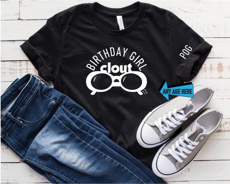 May include: Black t-shirt with the words "BIRTHDAY GIRL clout" and a pair of white glasses. The shirt is paired with blue jeans and gray sneakers. The text "ANY AGE HERE" is on a blue arrow.