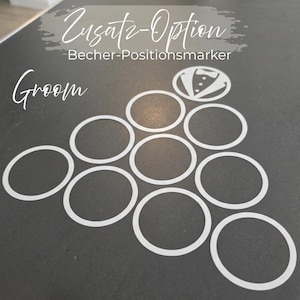 May include: A set of white vinyl decals arranged in a triangle formation, featuring ten circular outlines and one circular icon depicting a tuxedo jacket with a bowtie. The text reads "Zusatz-Option Becher-Positionsmarker" and "Groom".