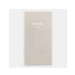 May include: A beige notebook with the word "GRID" in white lettering at the top. The notebook has a simple, minimalist design, with a smooth, matte finish. The notebook is rectangular and appears to be closed.