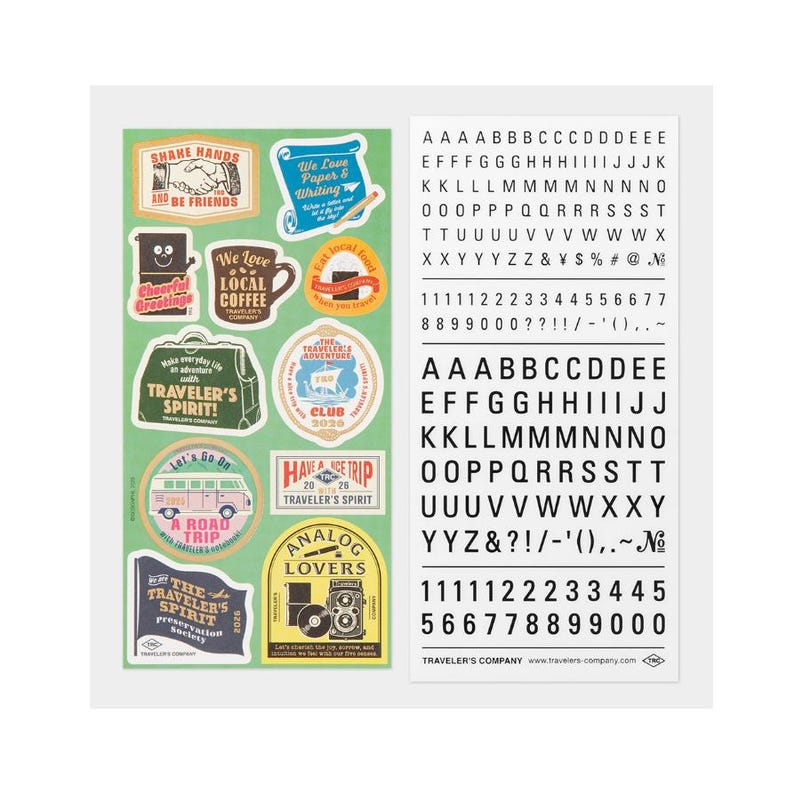 May include: A sheet of green stickers featuring travel-themed designs and a separate sheet of black letters and numbers. The stickers include phrases such as "Traveler's Spirit" and "Local Coffee".