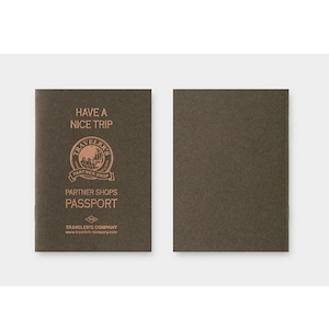 May include: Two brown passport covers. The left cover has the text "HAVE A NICE TRIP" above a circular logo with the words "TRAVELER'S" and "PARTNER SHOP". Below the logo is "PASSPORT". The right cover is blank.