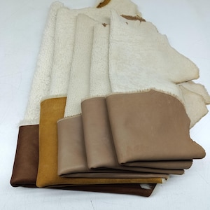 Op de afbeelding: Een verzameling stofstalen, waaronder leer en imitatiebont, in verschillende tinten bruin, beige en crème. De stalen zijn gelaagd en tonen de verschillende texturen en kleuren van de materialen.