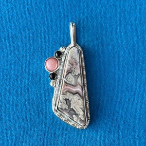 May include: A set of three ceramic mugs with a speckled, matte finish. The mugs are in shades of cream, light gray, and dark gray. Each mug has a simple, minimalist design, perfect for coffee or tea.