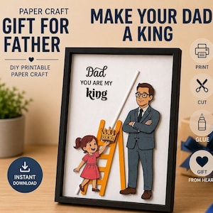 May include: A framed paper craft project featuring a cartoon illustration of a child on a ladder placing a crown on a man in a suit. The text reads: PAPER CRAFT GIFT FOR FATHER, MAKE YOUR DAD A KING, Dad YOU ARE MY king, PRINT, CUT, GLUE, GIFT FROM HEART.