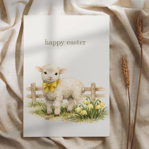 May include: A watercolor Easter card featuring a lamb with a yellow bow tie standing in front of a wooden fence and yellow flowers. The words "happy easter" are printed at the top of the card.