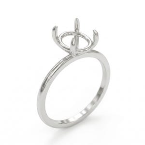 May include: A silver ring setting with a four-prong design to hold a gemstone. The ring has a slender band and a raised setting, designed to showcase a round-cut stone. The metal has a polished, reflective surface.
