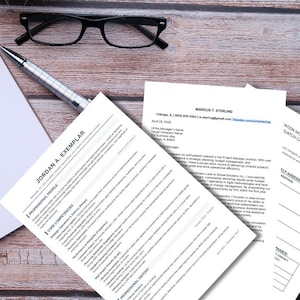 May include: A top-down view of a wooden desk with a resume, a notepad, a pen, and eyeglasses. The resume has the name "JORDAN A. EXEMPLAR" at the top. The glasses are black, and the pen is silver.