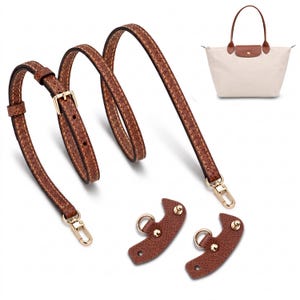 Puede incluir: Una correa de hombro ajustable de cuero marrón con mosquetones de metal dorado y dos pestañas de fijación de cuero marrón a juego con anillos y tachuelas doradas, junto a un bolso tote beige con asas marrones.