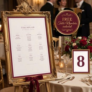 May include: A gold-framed seating chart with a burgundy border and a matching bow. The chart displays names and table assignments. A small framed table number 8 is on the table. The image includes a sign that says "Free Table Numbers included".