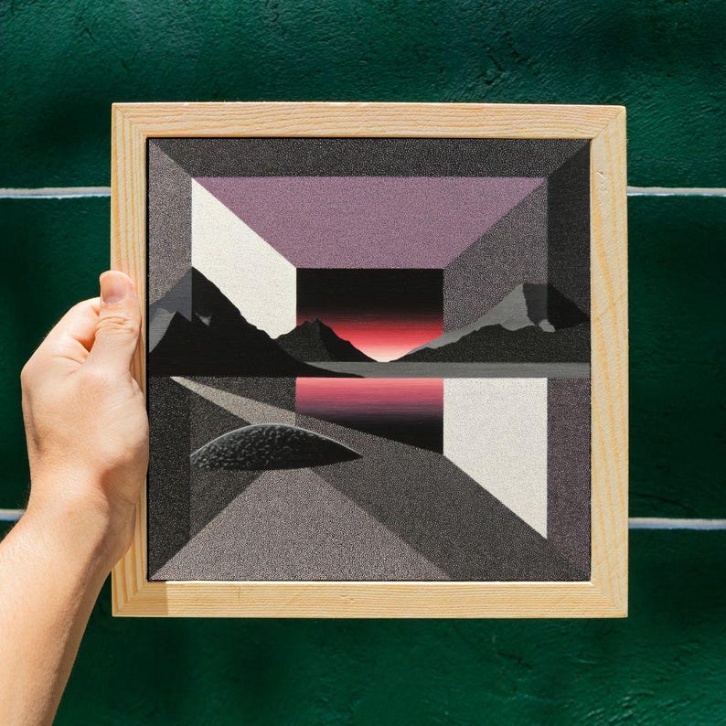 May include: Geometric landscape art print in a natural wood frame. The artwork features a stylized mountain range, a body of water, and geometric shapes in shades of gray, white, and purple. The sky has a gradient of red and black.