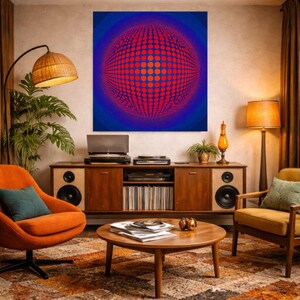 May include: A living room with a mid-century modern aesthetic, featuring a large abstract artwork with a red and blue spherical design. A wooden cabinet holds a record player and speakers. The room is furnished with orange and yellow armchairs and a round coffee table.