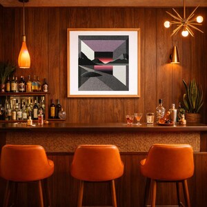 May include: A mid-century modern home bar with a framed abstract landscape art piece. The bar features orange bar stools, a wooden countertop, and a selection of liquor bottles. The walls are paneled with dark wood.