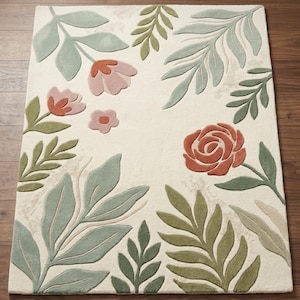 Alfombra botánica de lana tejida a mano, estilo bohemio cottagecore con hojas de salvia y flores de terracota.