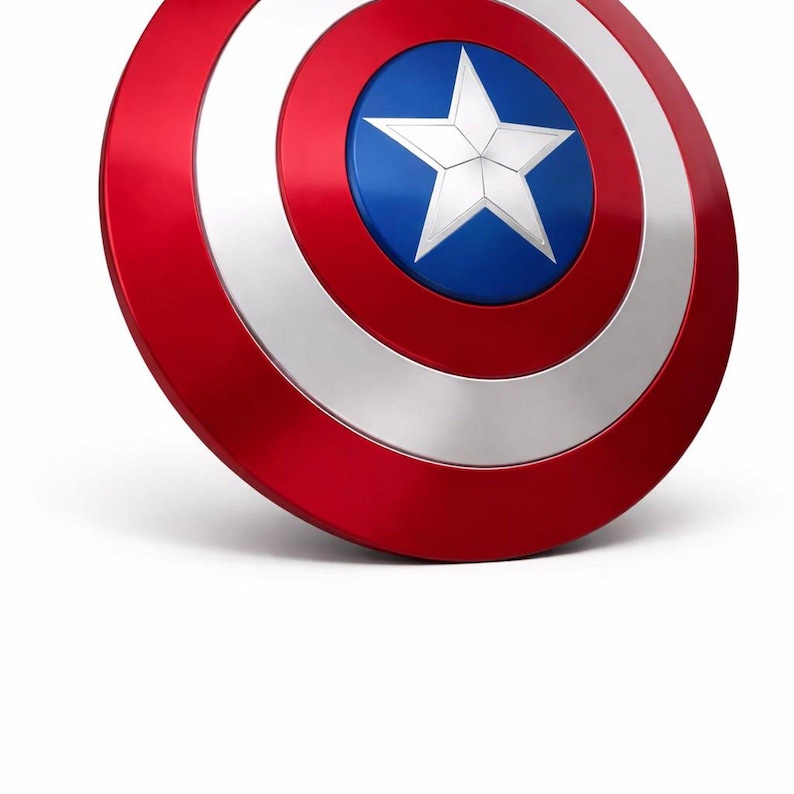 May include: A red, white, and blue shield with a star in the center. The shield has a circular design with a red outer ring, a silver middle ring, and a blue center with a white star. The shield is a prop or collectible.