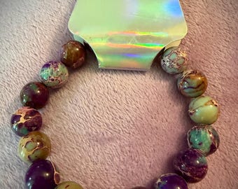 Purple sea sediment jasper on stretch cord.