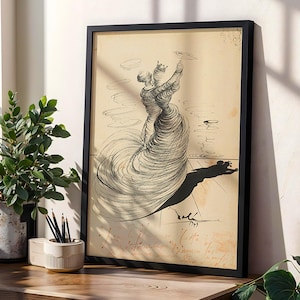 May include: A framed black and white artwork featuring a surrealist drawing of a figure with a flowing dress. The artwork is displayed on a wooden surface next to a potted plant and a pencil holder. The artwork is signed and dated.
