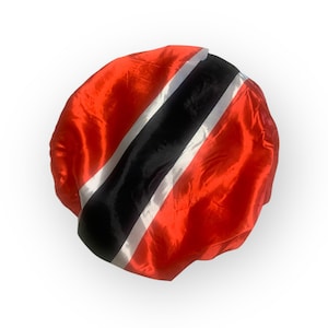 May include: A round, red satin cap with a black stripe and two white stripes. The cap is a vibrant red color and has a shiny, reflective surface. The stripes are diagonal across the cap.