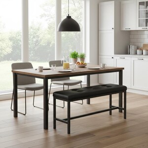 May include: A modern dining set in a bright kitchen. The set includes a rectangular wooden table with black metal legs, two gray upholstered chairs, and a black leather bench. A black pendant light hangs above the table. The room has large windows and white cabinets.
