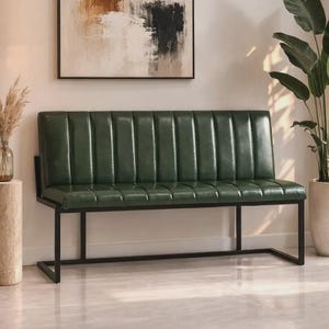 May include: A green leather bench with a black metal frame. The bench has a vertically ribbed back and a rectangular seat. The frame has a simple, modern design. The bench is placed in front of a wall with a painting.