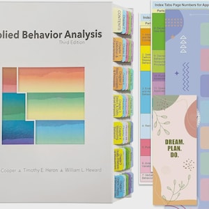 May include: A textbook titled "Applied Behavior Analysis, Third Edition" with colorful tab dividers. The tabs are labeled with chapter titles. A bookmark with the text "DREAM. PLAN. DO." is also visible.