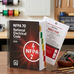 May include: A spiral-bound NFPA 70 National Electrical Code 2020 Edition book with index tabs. The cover features the NFPA logo with a lightning bolt symbol. A multimeter and screwdrivers are on a wooden surface.
