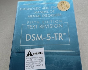 Libro de tapa blanda del DSM-5 TR con pestañas de índice de colores – Guía de salud mental