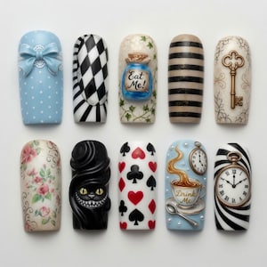 May include: A collection of ten artificial nails with various designs. The designs include a blue bow, black and white checkered pattern, a blue bottle with "Eat Me!" text, black and beige stripes, a gold key, floral patterns, a black Cheshire Cat, card suits, a teacup with "Drink Me" text, and a pocket watch.