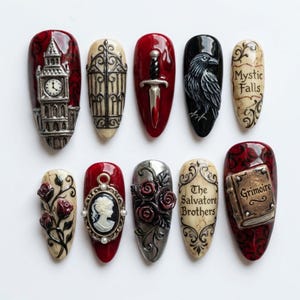 May include: A collection of ten intricately designed nail art pieces. Each nail features a unique design, including a clock tower, a gate, a dagger, a raven, and the words "Mystic Falls" and "The Salvatore Brothers". Other nails showcase roses, a cameo, and a book.
