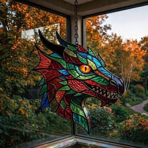 May include: A stained glass dragon head, suspended by a chain. The dragon is a mosaic of colours: red, green, blue, and yellow. The eye is bright orange. The background shows trees and a path, viewed through a window.