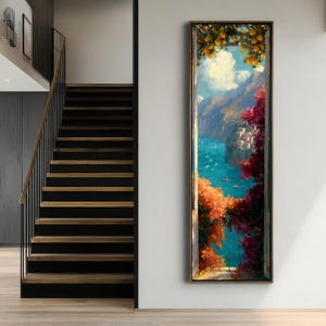 Può includere: Un'opera d'arte da parete incorniciata, alta e rettangolare, che raffigura una scena costiera mediterranea vista attraverso una finestra aperta. L'immagine presenta limoni gialli brillanti, bouganville rosa e un mare blu intenso.