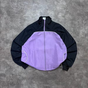 Vintage Reebok Windbreaker Damen S 90s Lila Schwarz Colorblock Nylon Track Jacket Retro Sportjacke
