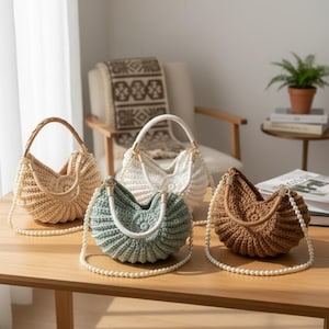 May include: Four handmade crochet bags in beige, white, seafoam green, and brown, each with a unique design. The bags have handles and pearl-like straps, displayed on a wooden table. The bags are a mix of textures and colors.