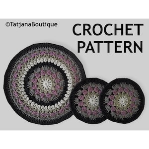May include: A crochet pattern featuring a circular design in shades of black, gray, white, and purple. The pattern includes a large mat and two smaller coasters. The text "CROCHET PATTERN" is displayed in bold, black letters.