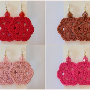 May include: Four pairs of crocheted flower earrings with gold hooks and glass beads. The earrings are in red, brown, pink, and fuchsia.