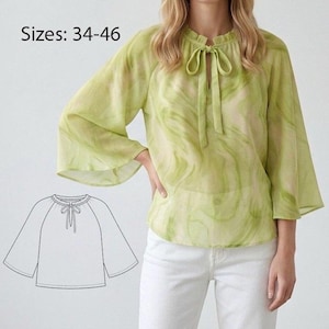 Puede incluir: Una blusa verde claro con detalle de lazo en el cuello y mangas acampanadas. La blusa tiene una tela fluida y semitransparente con un diseño veteado. La imagen también incluye un dibujo lineal de la blusa y el texto "Tallas: 34-46".