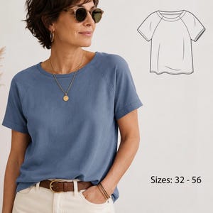 May include: A blue short-sleeved t-shirt with raglan sleeves and a round neckline. The shirt features a folded cuff detail on the sleeves. A black and white line drawing of the shirt design is shown in the top right corner with text Sizes: 32 - 56.