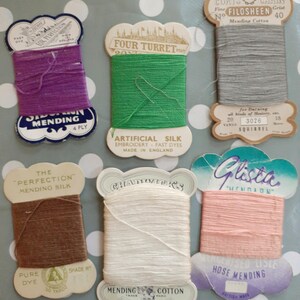 May include: Assortment of vintage thread spools for mending and embroidery. The spools are labelled with brand names such as "Four Turret", "The Perfection", "Glasta", "Chadwick's", and "Coats Chain". The thread colours include purple, green, grey, brown, white, and pink.