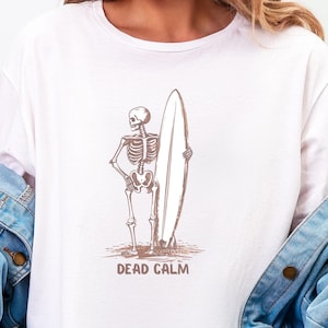 Skeleton Surfing T-Shirt, Dead Calm Beach Tee, Ocean Lover Gift, Halloween Graphic Top, Surfer Skeleton Shirt, Gothic Beach Goth Tee