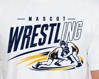 May include: A white t-shirt featuring a graphic of two wrestlers in yellow and navy blue singlets engaged in a match. Above the wrestlers, the text reads MASCOT WRESTLING in bold navy blue letters with a distressed texture effect.