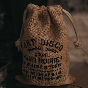 Hand printed hessian bag that the soy wax candles by Art Disco are packaged in