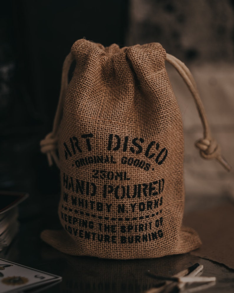 Hand printed hessian bag that the soy wax candles by Art Disco are packaged in