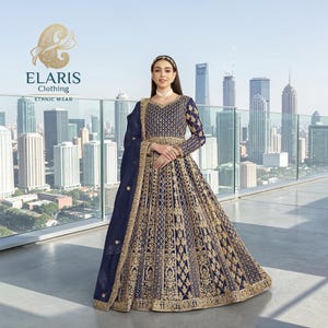 May include: A navy blue ethnic wear gown with intricate gold embroidery. The long-sleeved dress features a detailed bodice and a flowing skirt. The image includes the "ELARIS Clothing" logo and the words "Ethnic Wear". The background shows a cityscape.